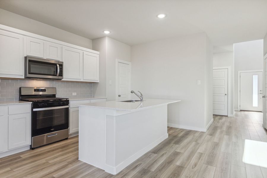 Kitchen in the Willow home plan by Trophy Signature Homes – REPRESENTATIVE PHOTO