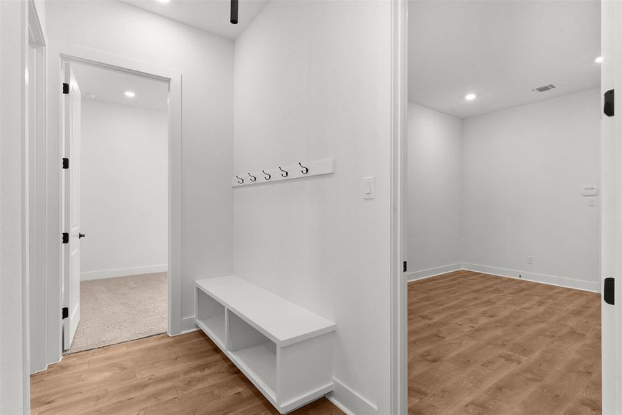 Mudroom featuring light wood-type flooring and recessed lighting
