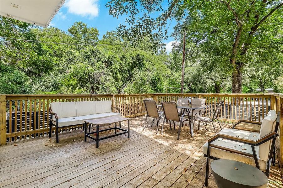 Enjoy outdoor gatherings on the spacious wood deck, offering views of the surrounding natural landscape.