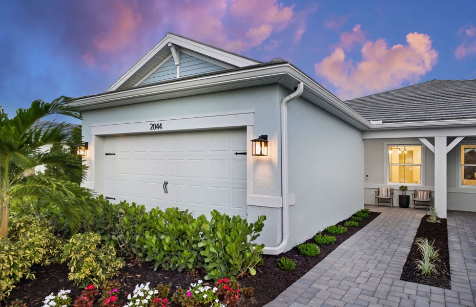Front exterior of a new home in Shores at Stillwater, Englewood, FL, highlighting curb appeal (Image 1). Front exterior of a new home in Shores at Stillwater, Englewood, FL, highlighting curb appeal (Image 1).