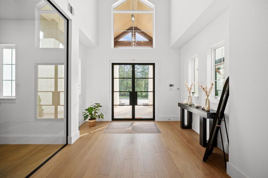 Grand foyer designed to showcase the home's soaring ceilings and open-concept layout.