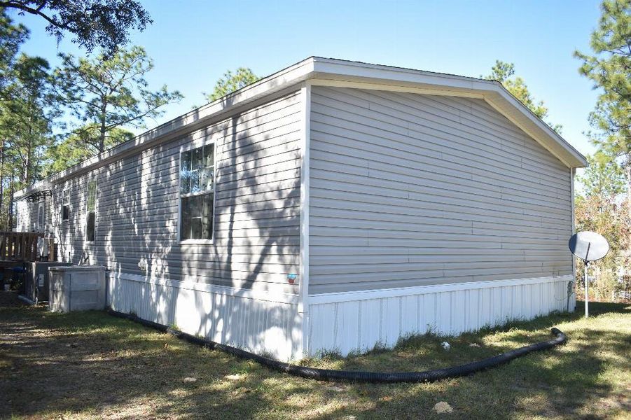 Exterior details and patio area of a home in , Williston (Image 34).