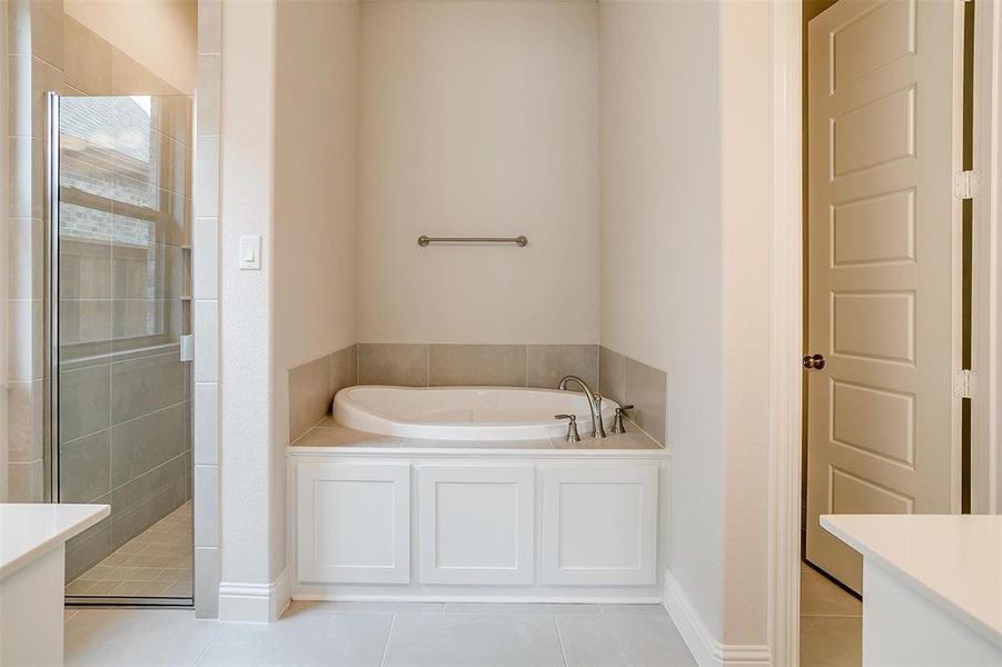 Bathroom with vanity, independent shower and bath, and tile patterned flooring