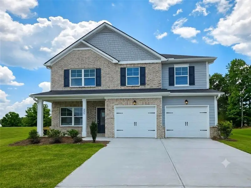Front exterior of a new home in The Hills at Cedar Creek, Winder, GA, highlighting curb appeal (Image 1). Front exterior of a new home in The Hills at Cedar Creek, Winder, GA, highlighting curb appeal (Image 1).