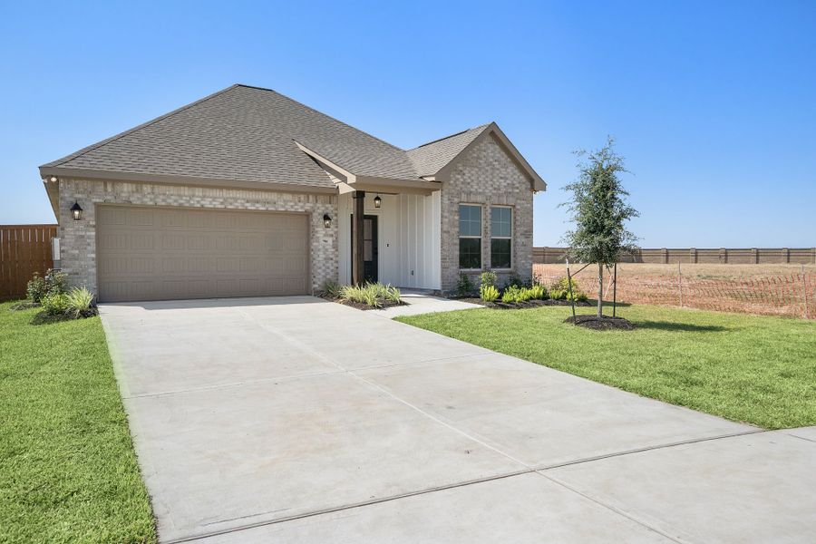 Front exterior of a new home in Emberly 55, Beasley, TX, highlighting curb appeal (Image 17). Front exterior of a new home in Emberly 55, Beasley, TX, highlighting curb appeal (Image 17).