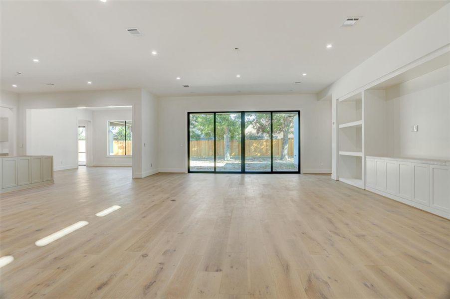 View of the first floor open concept living joining the great room, kitchen and dining. Open the expansive sliders onto the lanai and into the spacious backyard. View of the first floor open concept living joining the great room, kitchen and dining. Open the expansive sliders onto the lanai and into the spacious backyard.