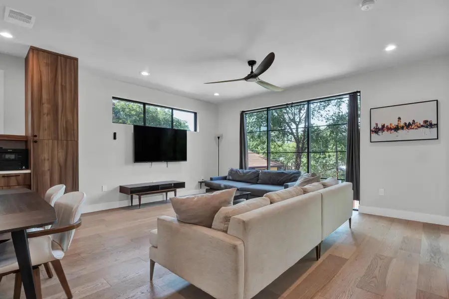 Living area with recessed lighting, light wood-style floors, and ceiling fan