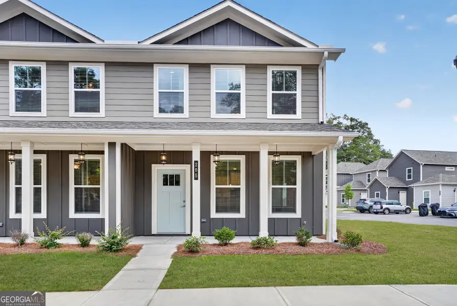 Front exterior of a new home in The Cottages at East Lanier, Fayetteville, GA, highlighting curb appeal (Image 2). Front exterior of a new home in The Cottages at East Lanier, Fayetteville, GA, highlighting curb appeal (Image 2).