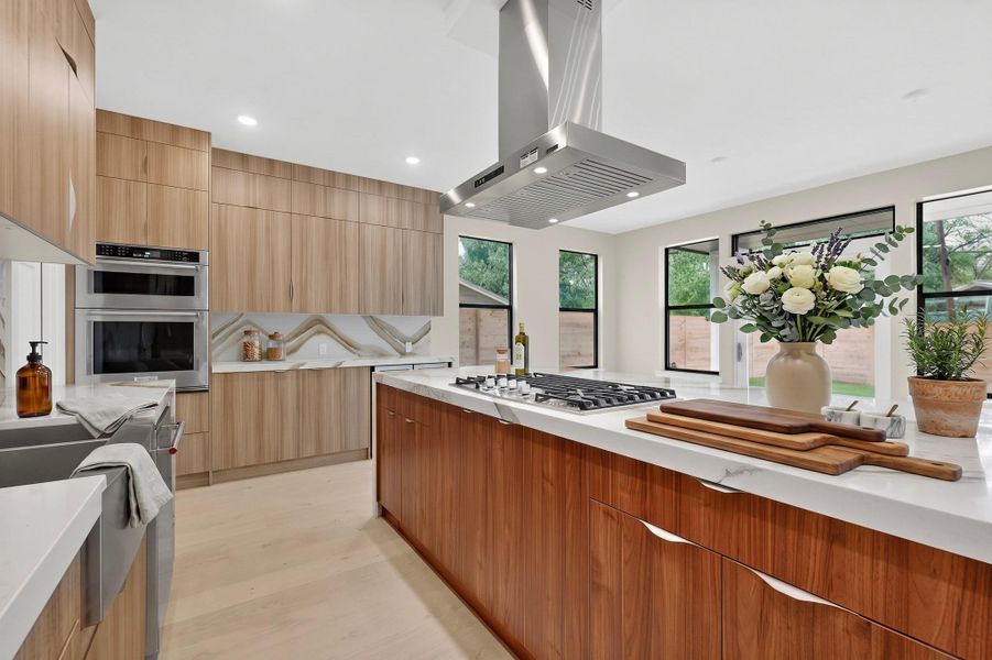 Culinary aspirations find their home in this kitchen, boasting pristine countertops and high-end built-in appliances.