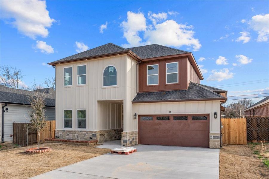Traditional home with a shingled roof, concrete driveway, stone siding, and board and batten siding Traditional home with a shingled roof, concrete driveway, stone siding, and board and batten siding