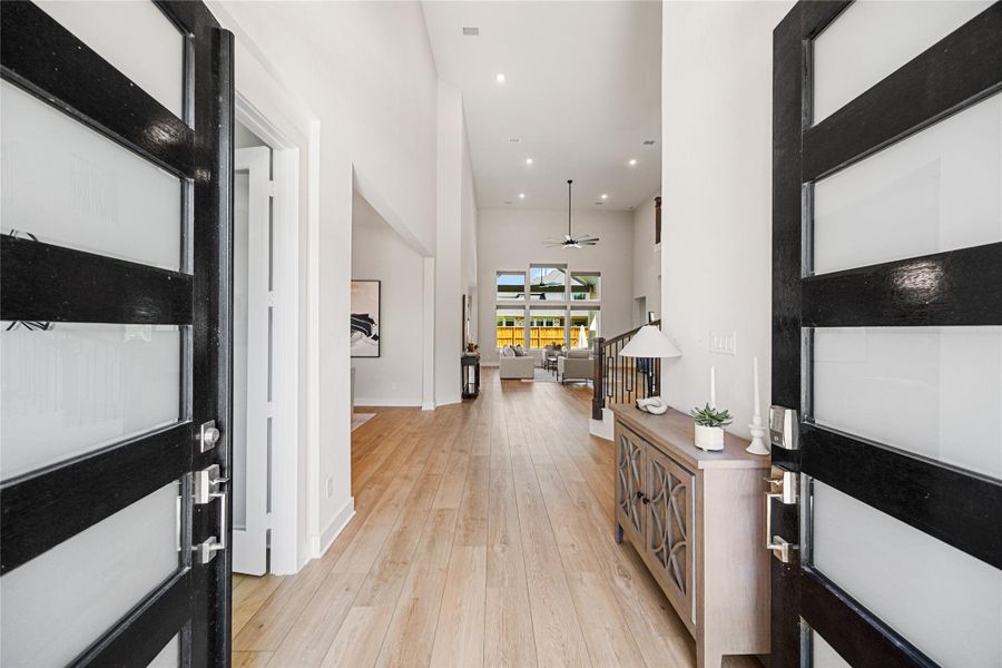 Make a grand first impression with stunning double front doors that open to a breathtaking view straight through to the home's spectacular backyard oasis.