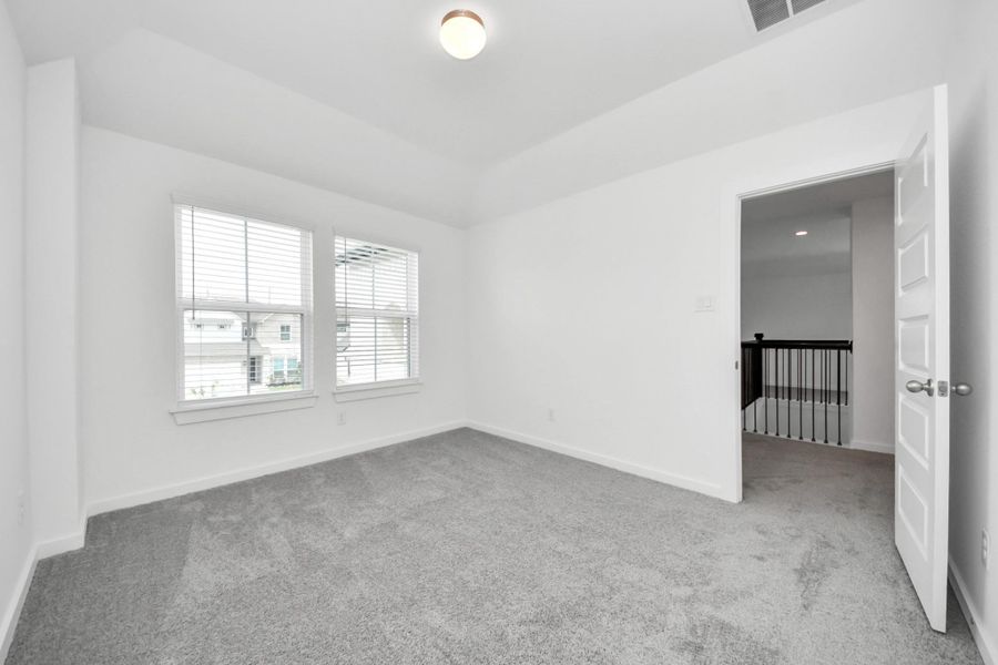 Generously sized secondary bedrooms featuring spacious closets, soft and inviting carpeting underfoot, large windows allowing plenty of natural light, and the added touch of privacy blinds for your personal retreat. Sample photo of completed home with similar floor plan. Actual colors and selections may vary. Generously sized secondary bedrooms featuring spacious closets, soft and inviting carpeting underfoot, large windows allowing plenty of natural light, and the added touch of privacy blinds for your personal retreat. Sample photo of completed home with similar floor plan. Actual colors and selections may vary.