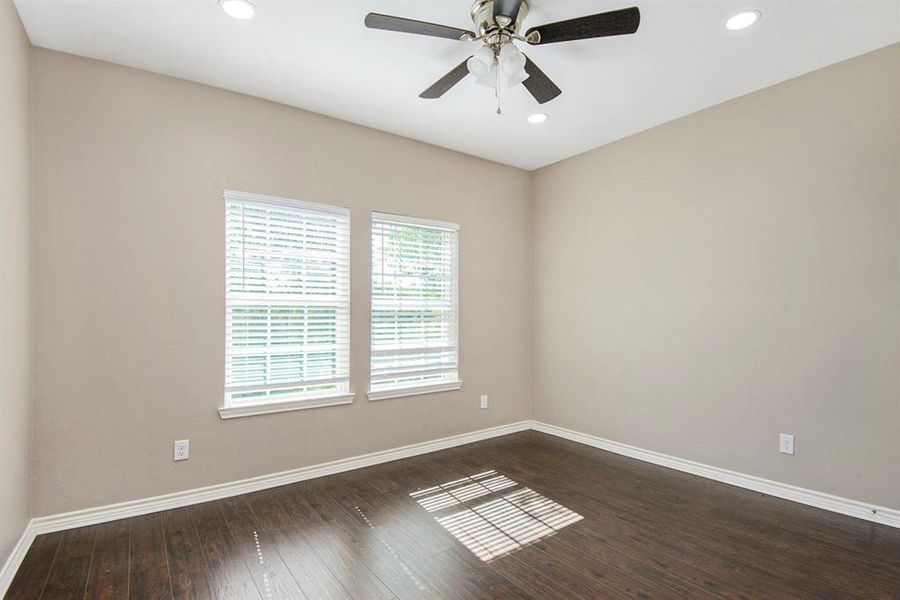 Spare room with dark wood-type flooring, ceiling fan, and recessed lighting