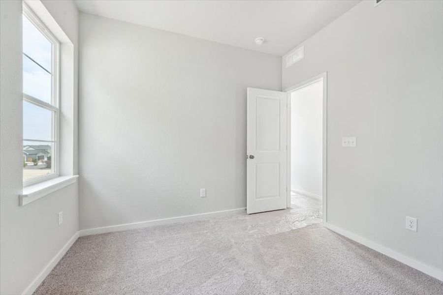 A room with white walls and a window. A room with white walls and a window.