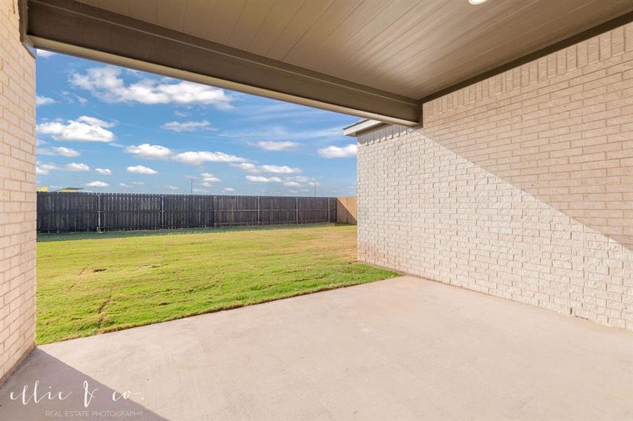 Fenced backyard with a patio area