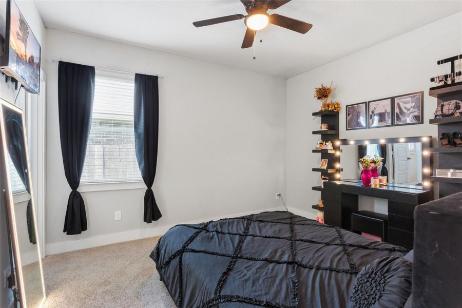 Spacious and inviting second bedroom with natural light, a ceiling fan, and ample space for personal touches. Spacious and inviting second bedroom with natural light, a ceiling fan, and ample space for personal touches.