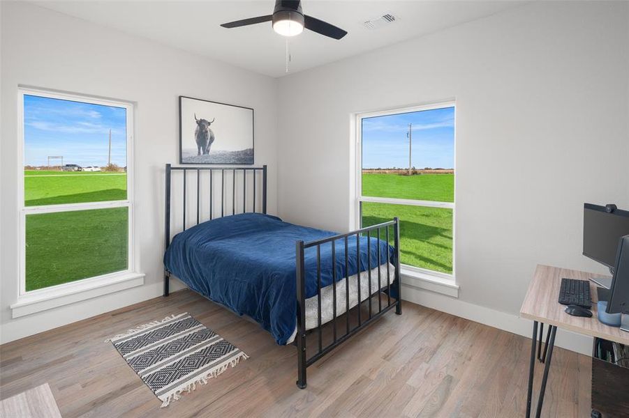 Bedroom featuring light wood-type flooring and ceiling fan