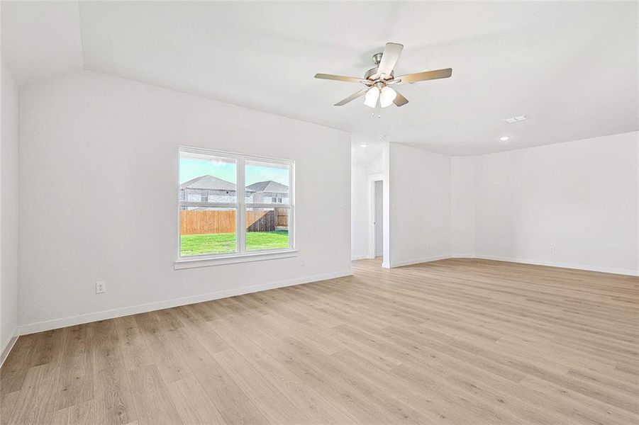 Unfurnished room with light hardwood / wood-style floors and ceiling fan