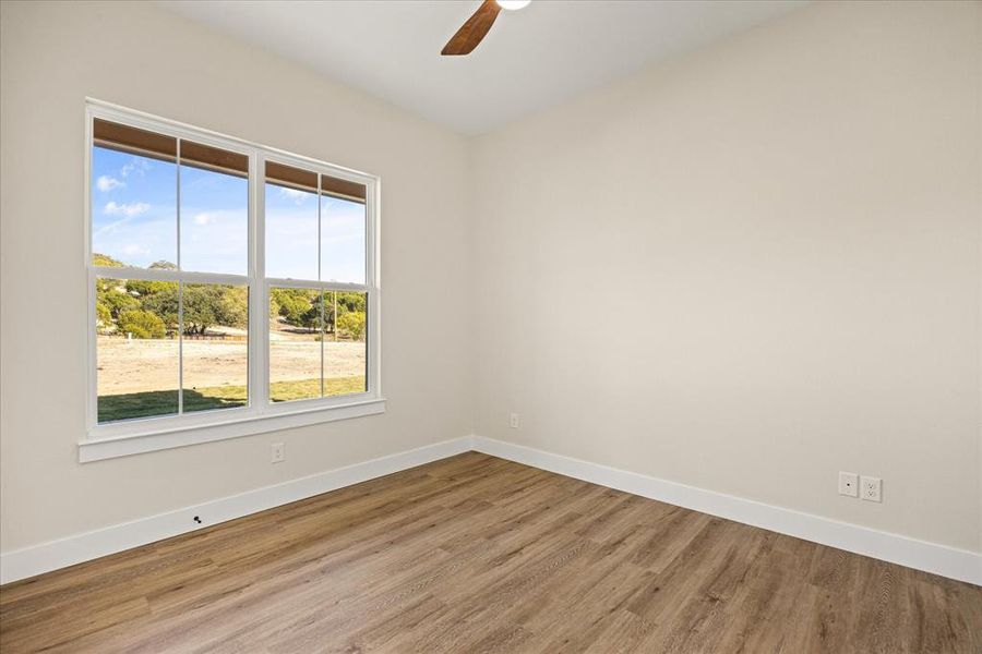 Bedroom featuring wood finished floors and a ceiling fan