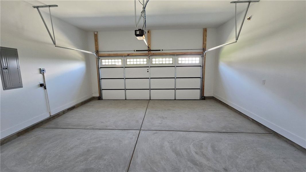 A spacious, newly finished garage offers ample par