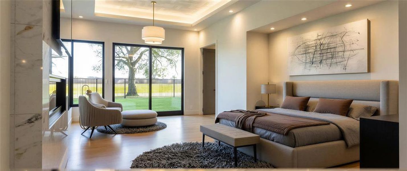 Bedroom with wood finished floors, access to exterior, a raised ceiling, and recessed lighting