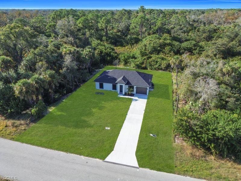 Front exterior of a new home in , Lehigh Acres, FL, highlighting curb appeal (Image 21).