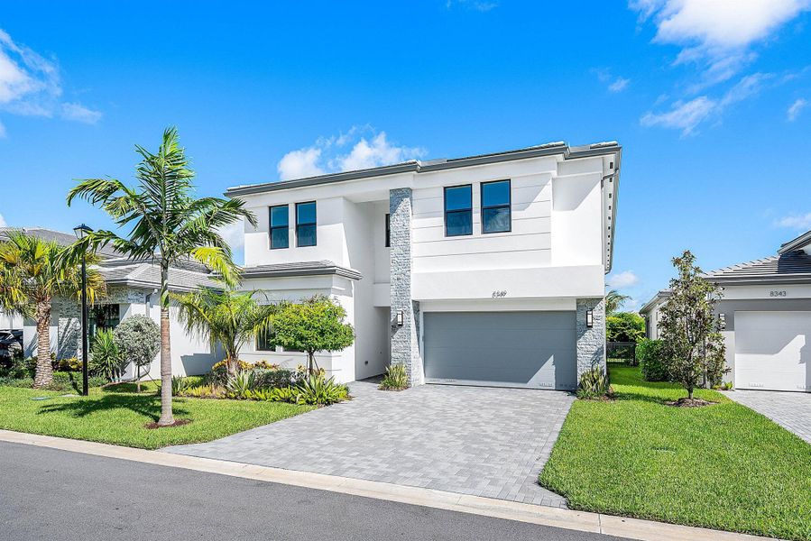 Front exterior of a new home in Lotus Edge, Boca Raton, FL, highlighting curb appeal (Image 31).