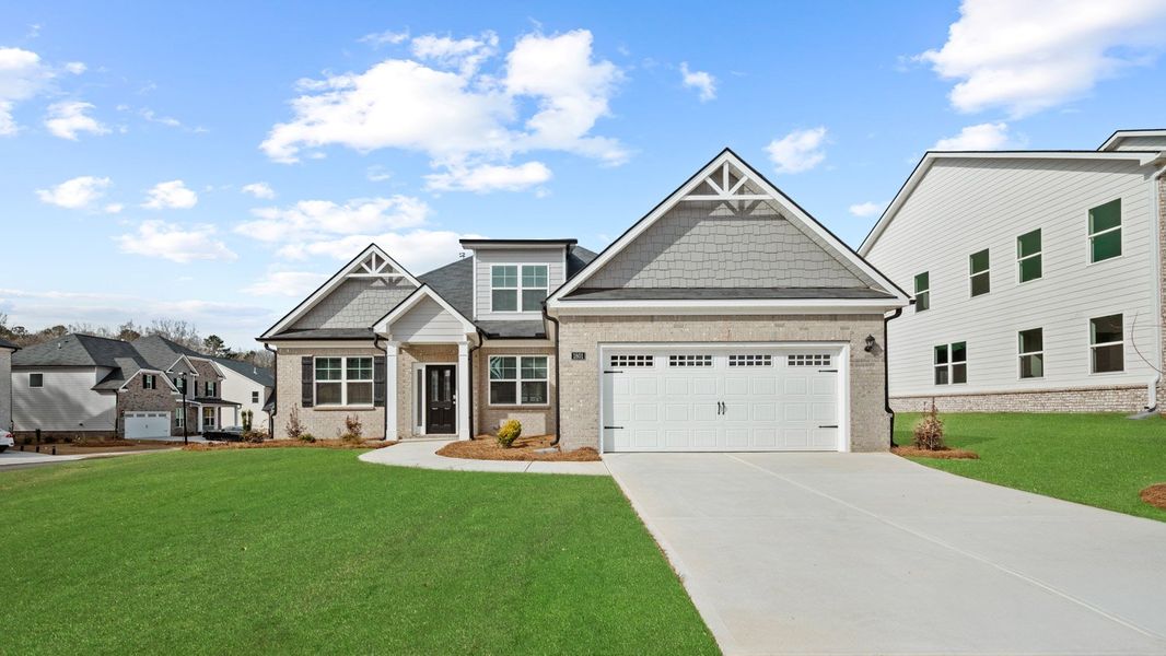 Front exterior of a new home in The Gates at Pates Creek, Hampton, GA, highlighting curb appeal (Image 1). Front exterior of a new home in The Gates at Pates Creek, Hampton, GA, highlighting curb appeal (Image 1).
