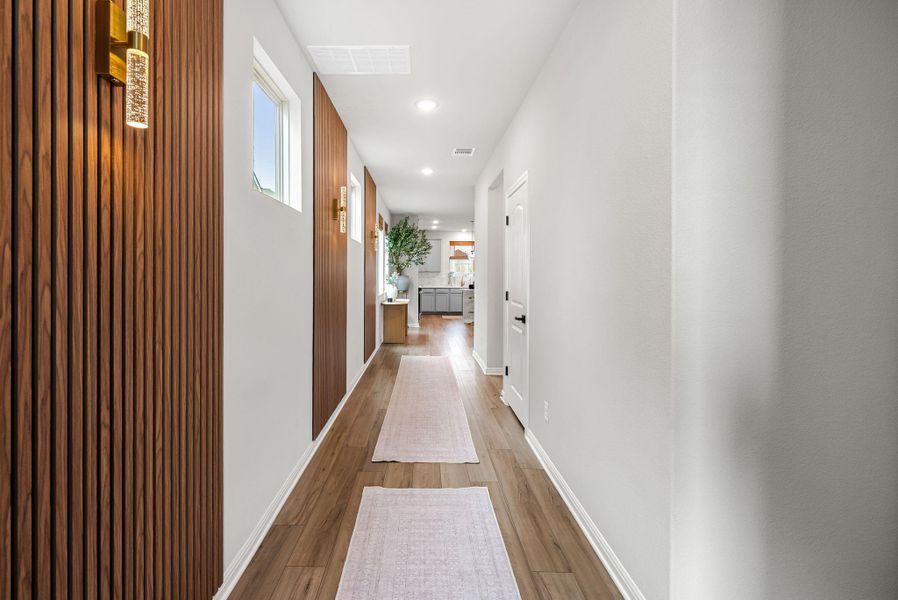Hallway with recessed lighting and light wood-style floors