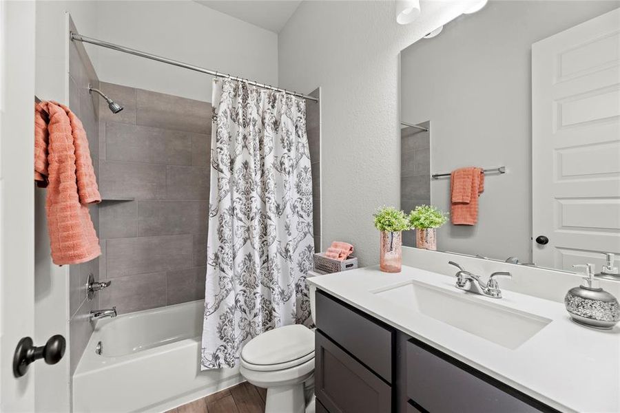 Full guest bathroom with a tub/shower combination.