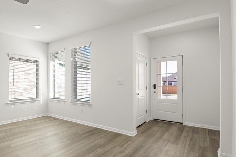 Entryway with light wood-style floors and baseboards