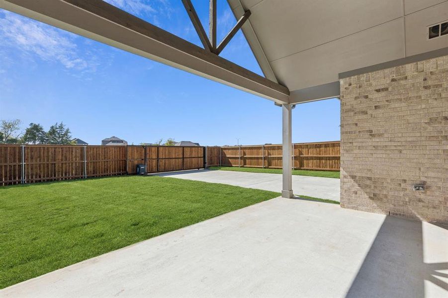 Fenced backyard with a patio area Fenced backyard with a patio area