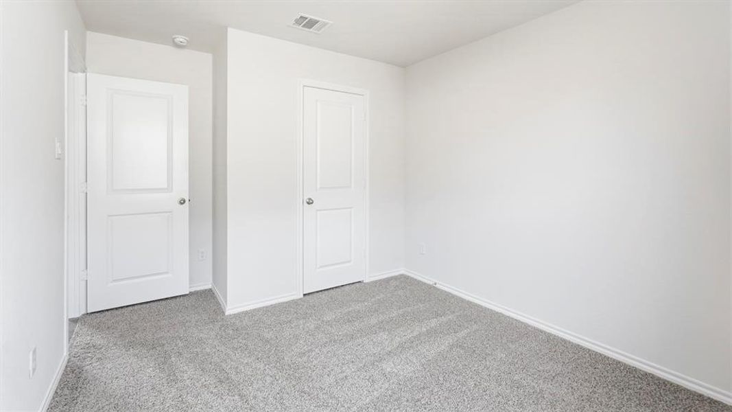 Unfurnished bedroom with carpet floors and a closet Unfurnished bedroom with carpet floors and a closet