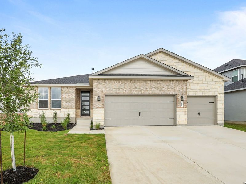 Front exterior of a new home in The Reserve at Potranco Oaks, Castroville, TX, highlighting curb appeal (Image 27).