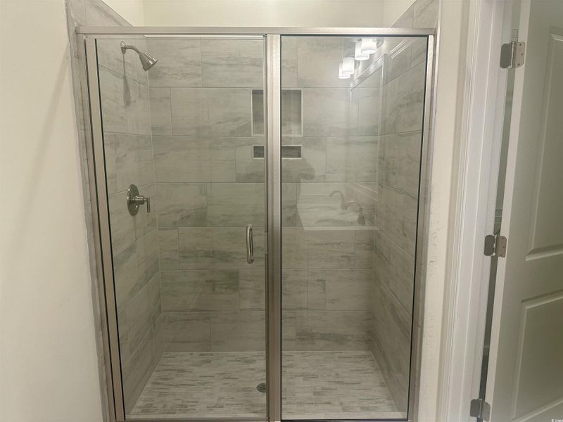 Full bath with a tile shower