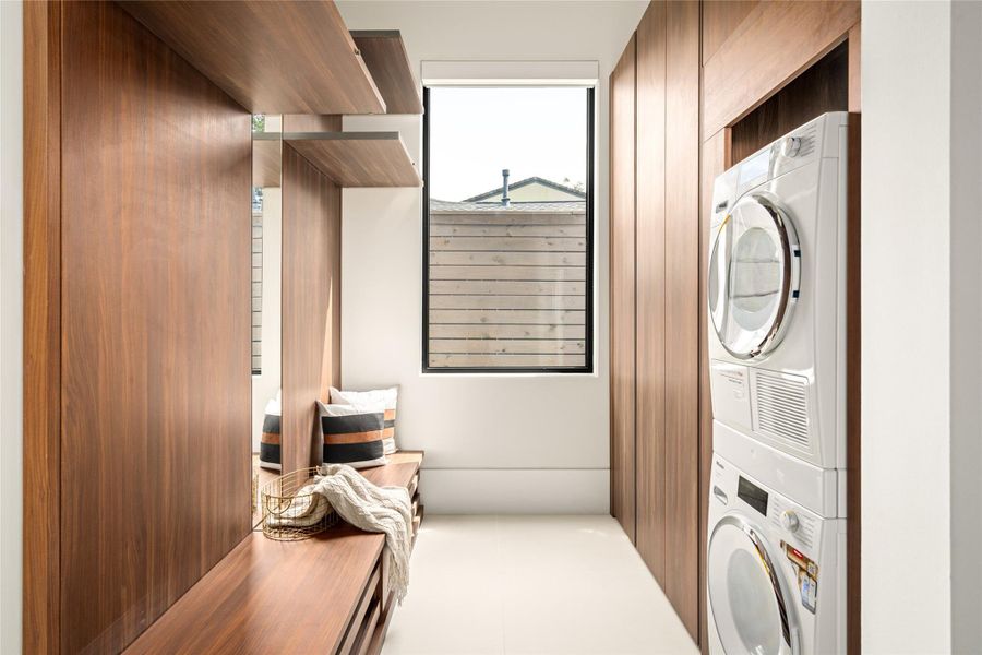 Well-designed utility space with custom built-ins, integrated seating, and a dedicated laundry area.