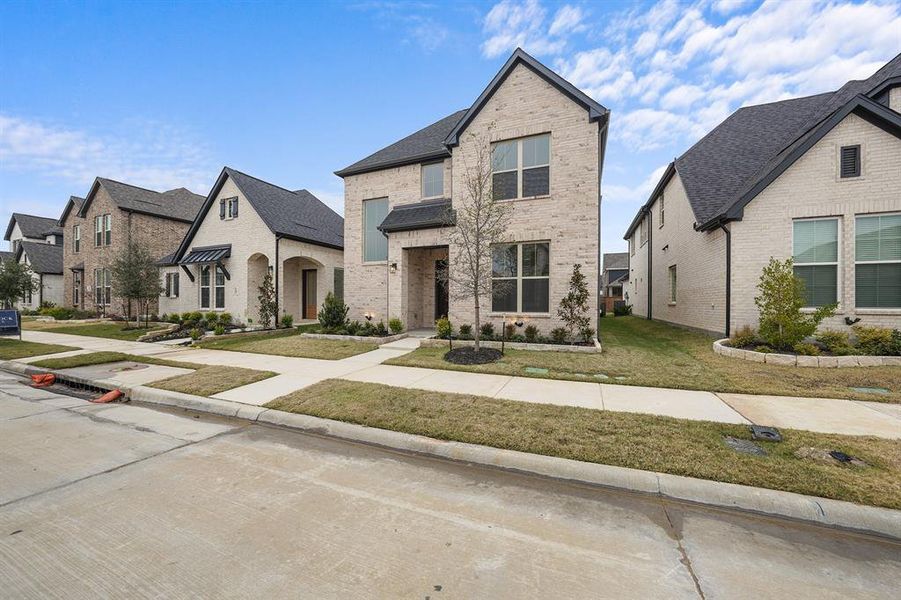 Front exterior of a new home in Cottages of Celina, Celina, TX, highlighting curb appeal (Image 23).