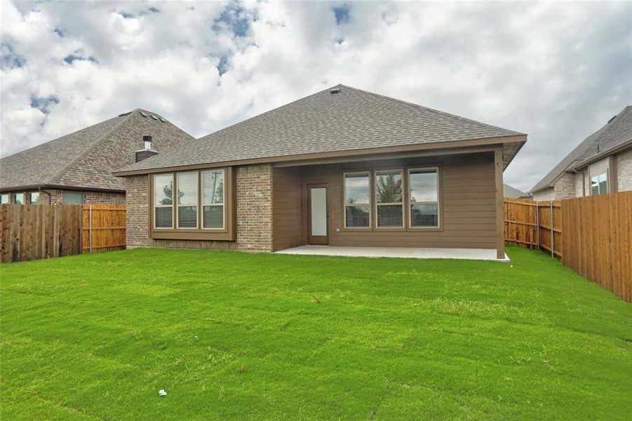 Back of property with a patio and a lawn