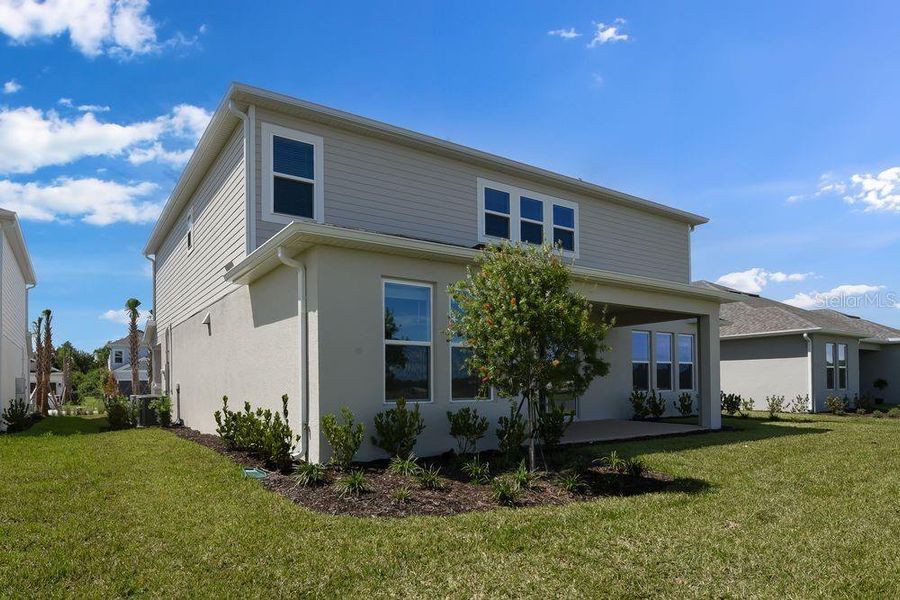 Front exterior of a new home in Ardisia Park, New Smyrna Beach, FL, highlighting curb appeal (Image 1).