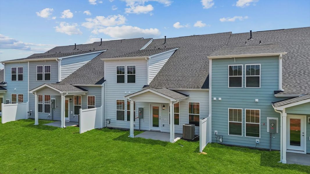 Refined rear exterior with a stylish covered porch for dining, relaxing, or entertaining at the Barton Hollow community