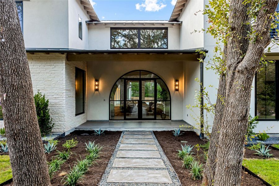 A stunning arched entryway welcomes you to this modern architectural residence.