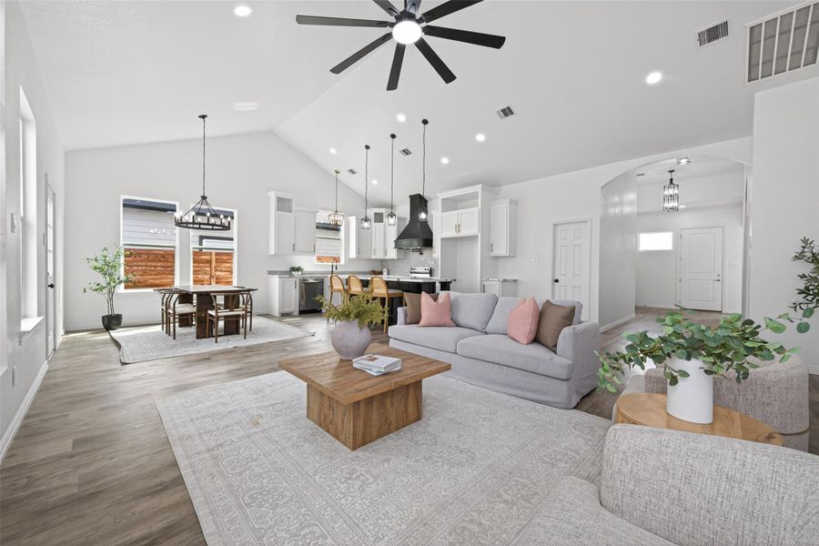 Open living area with impressive cathedral ceilings and abundant natural light.