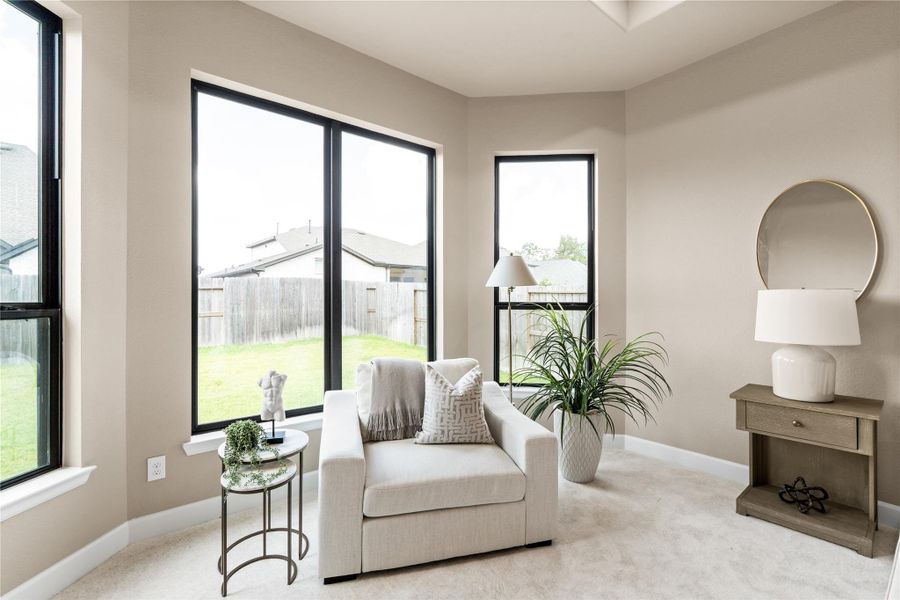 Enter into rest and relaxation in this comfortable seating area in your private primary retreat. It's the perfect place to escape after a long day. *Virtually Staged*