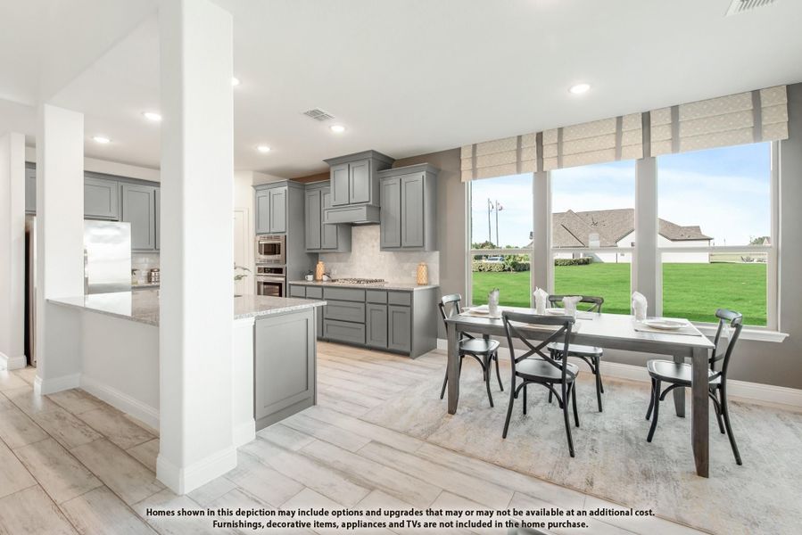 Open-concept kitchen and dining area with gray cabinets, large windows, and a six-seat dining table on light wood floors