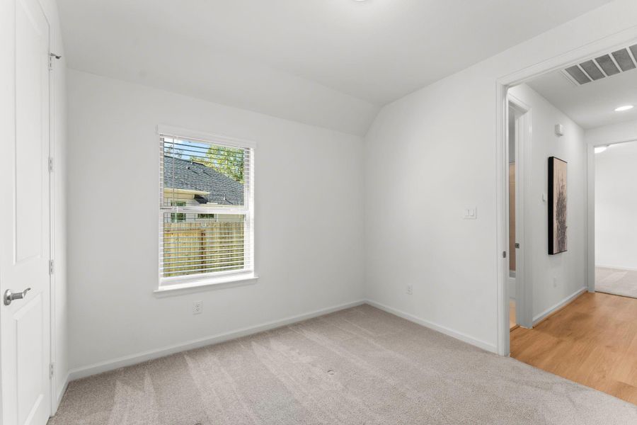 This split floor plan offers privacy with two secondary bedrooms located in their own hallway, featuring a bathroom conveniently accessible from the living area.