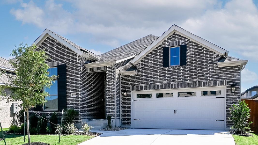 Front exterior of a new home in Crosswinds, Kyle, TX, highlighting curb appeal (Image 2). Front exterior of a new home in Crosswinds, Kyle, TX, highlighting curb appeal (Image 2).