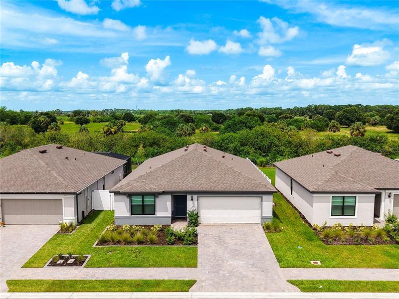 Front exterior of a new home in Caloosa Cove, Labelle, FL, highlighting curb appeal (Image 26).