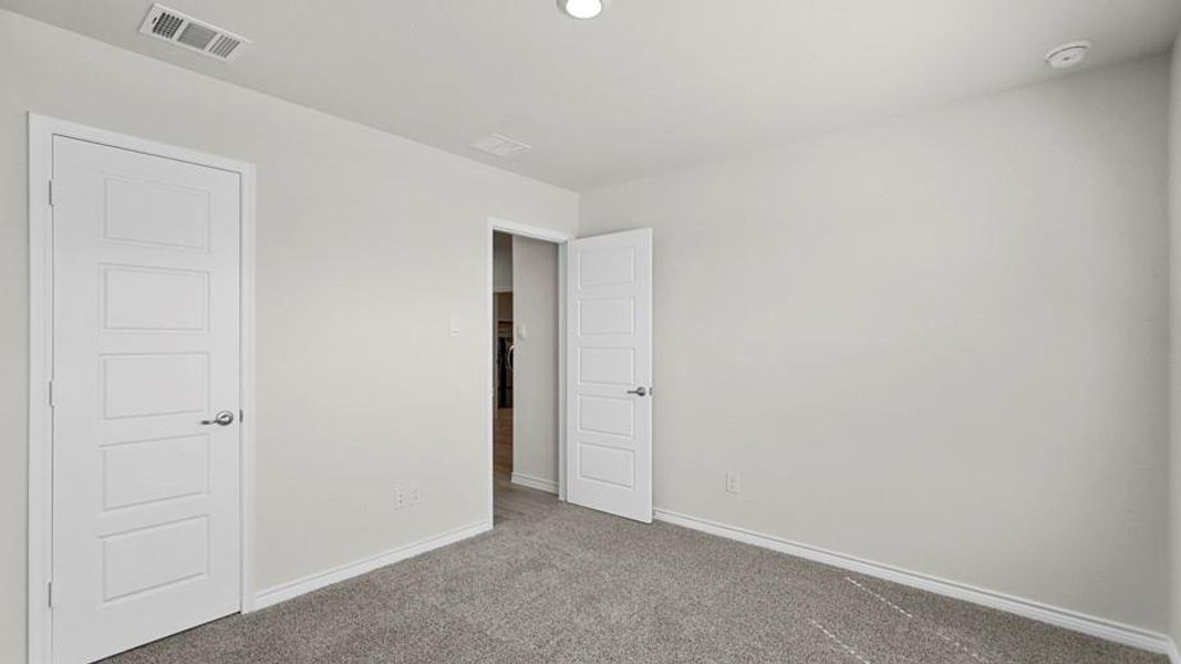 Neutral-toned room with light gray walls, gray carpeting, and white trim