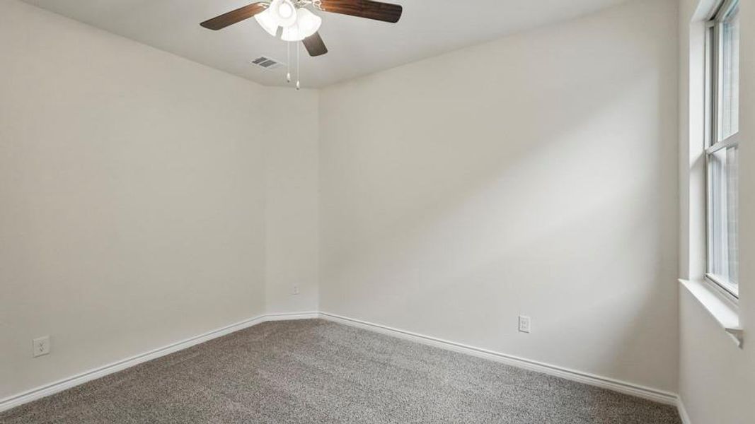 Room featuring light-toned walls, gray carpet, and white trim