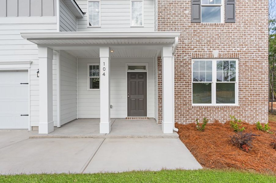Front exterior of a new home in Ramsey Landing, Rincon, GA, highlighting curb appeal (Image 20). Front exterior of a new home in Ramsey Landing, Rincon, GA, highlighting curb appeal (Image 20).